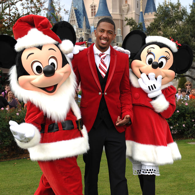 Nick Cannon and Maria Menounos get into the Xmas spirit at Disney World