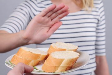 Gluten intolerance and diet concept Woman refuses to eat white bread Selective focus on bread El Digital de Asturias Gluten intolerance and diet concept. Woman refuses to eat white bread. Selective focus on bread
