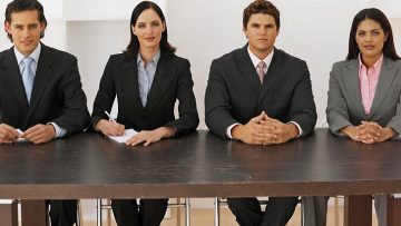 Front view portrait of four business executives sitting in a line El Digital de Asturias Front view portrait of four business executives sitting in a line --- Image by © Royalty-Free/Corbis